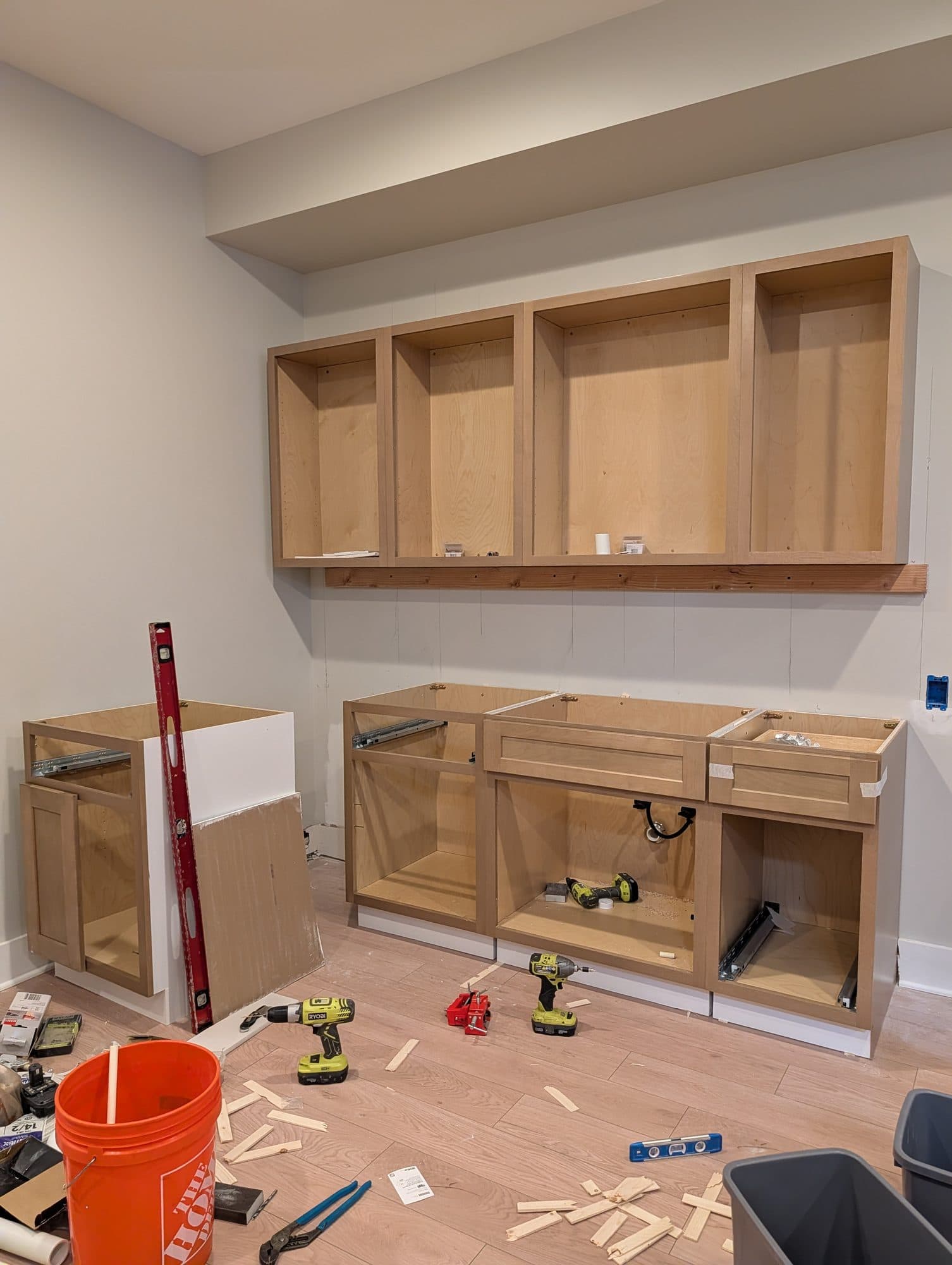 Basement wet bar cabinets being installed