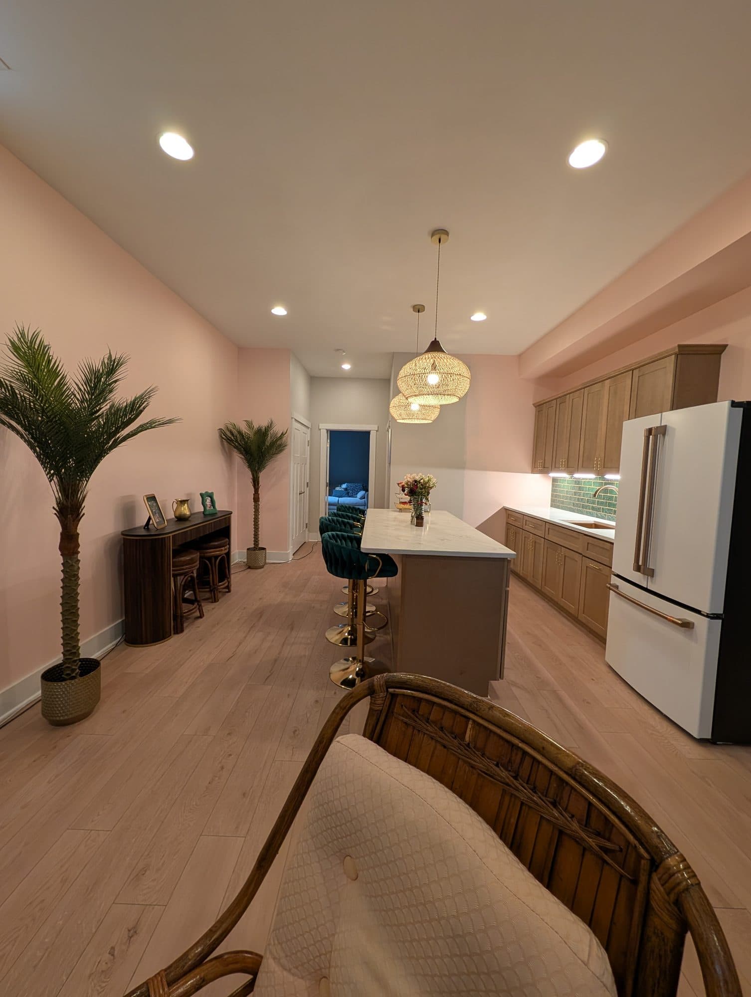 Finished basement living and bar area, fully furnished, with the wet bar in the background