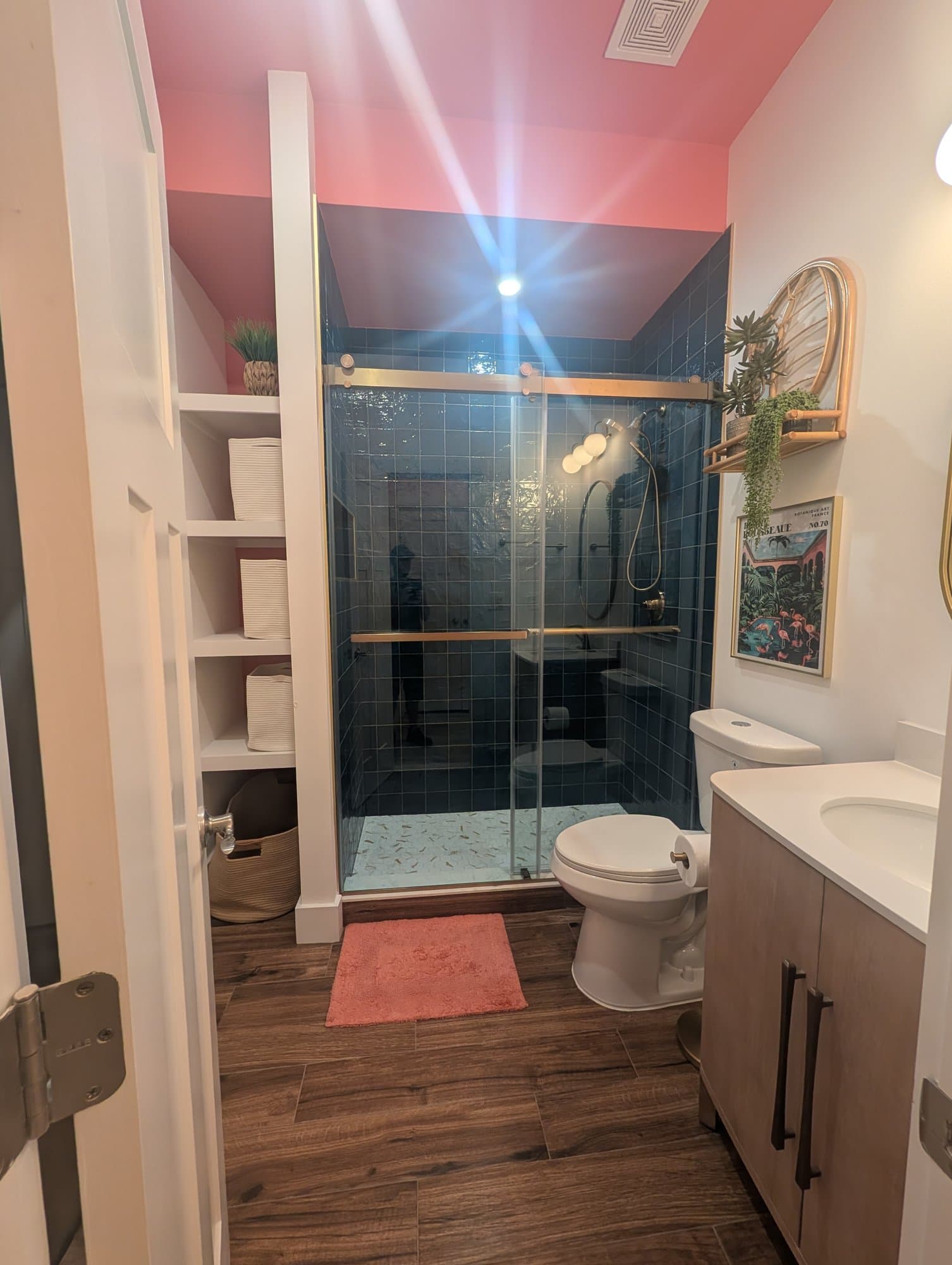 Finished basement bathroom with a glass-enclosed shower and blue tile, converted from a tub